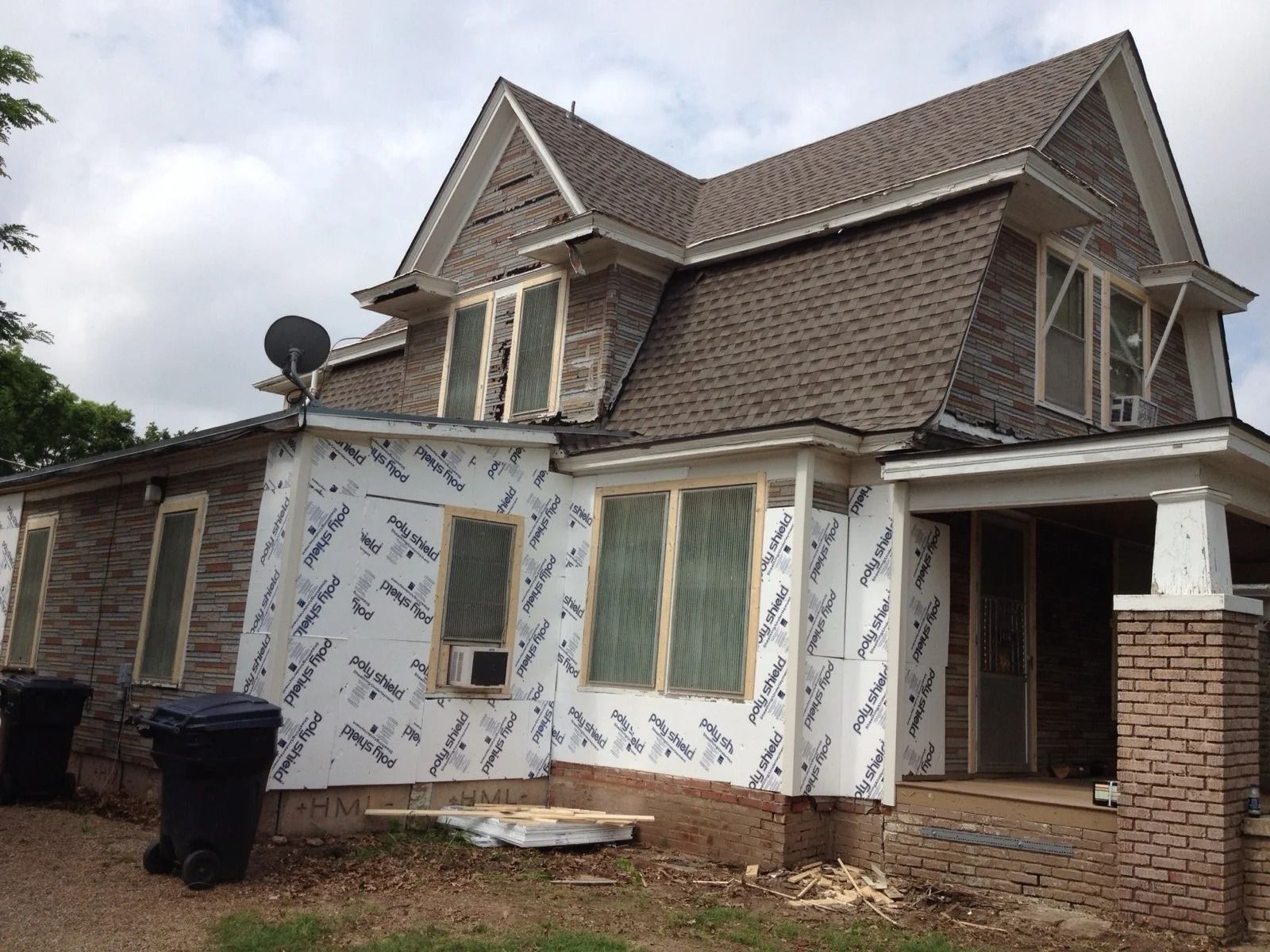 Home with house wrap exposed during siding replacement