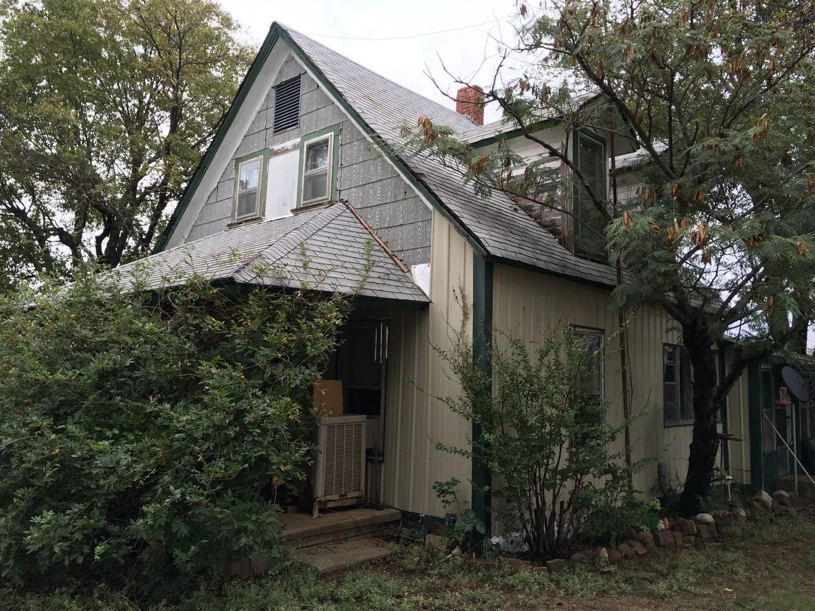 Older home with worn siding before replacement